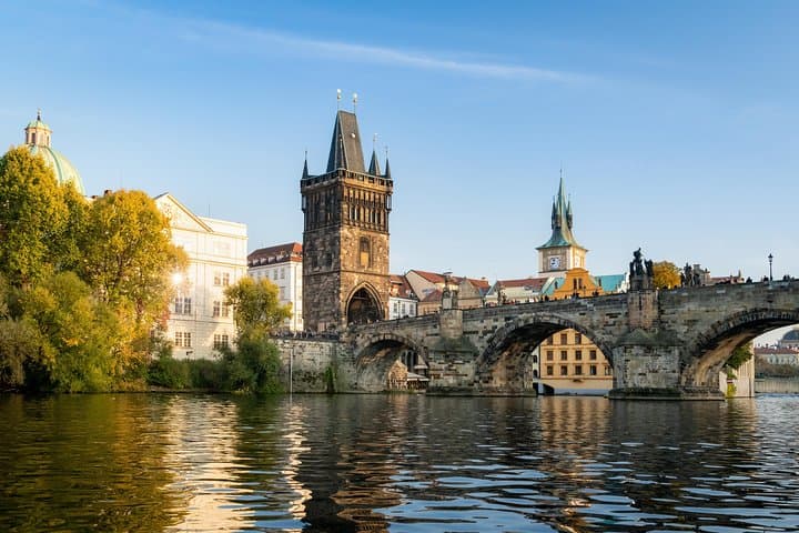 Charles Bridge and the Old Town Bridge Tower spans the Vltava River in Prague.
