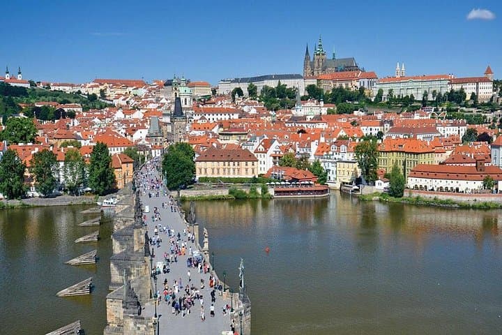 The Prague castle towering over the Vltava river and the Charles bridge