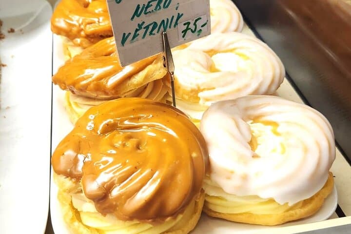 Větrník is a delectable Czech dessert made from light choux pastry, filled with rich vanilla cream and caramel, and topped with a glossy caramel glaze. This indulgent pastry is delicious!