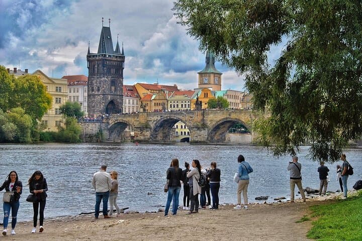 Charles Bridge – Walk Across Centuries of Stories
Cross the iconic 14th-century bridge lined with baroque statues and street performers, offering perfect photo moments over the Vltava River.