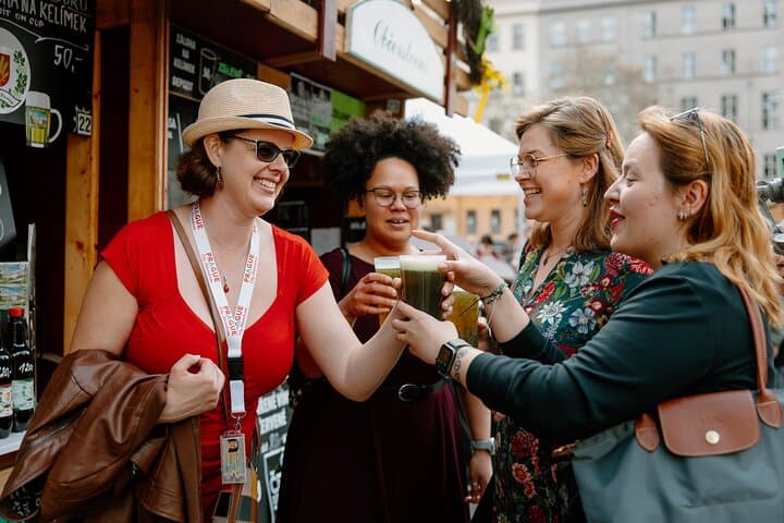 Local tour guide handing our green beer to her guests on a tour