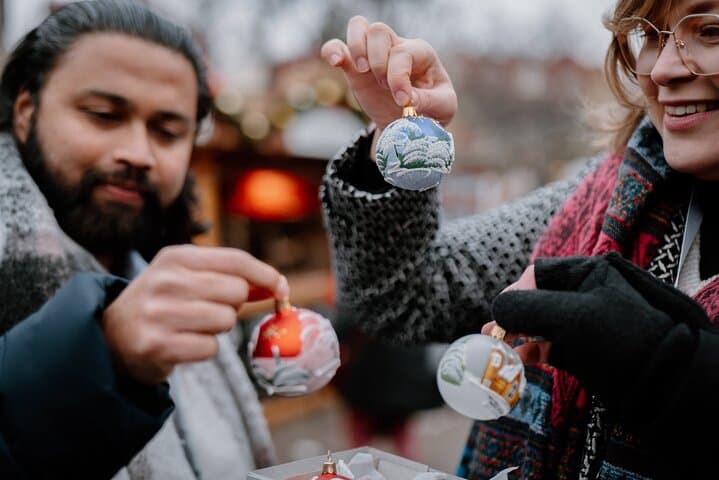 Choosing hand-painted glass baubles – a favorite souvenir on our Prague Christmas markets tour.