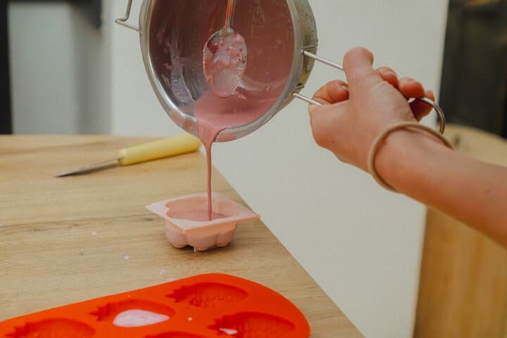 Pouring melted soap into silicone molds