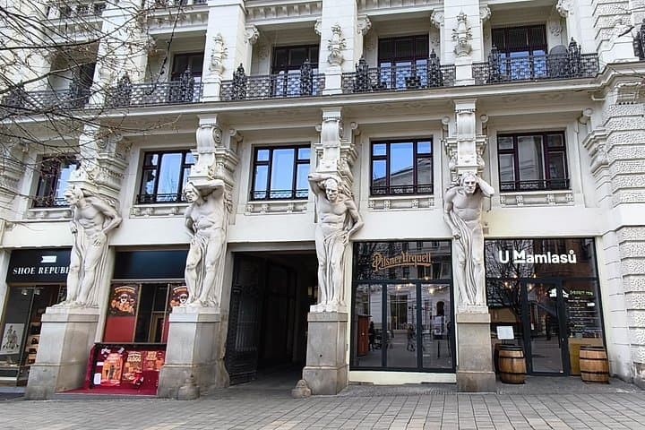 House at the Four Giants — a historic Brno townhouse named for the four sculpted figures that seem to support its balcony.