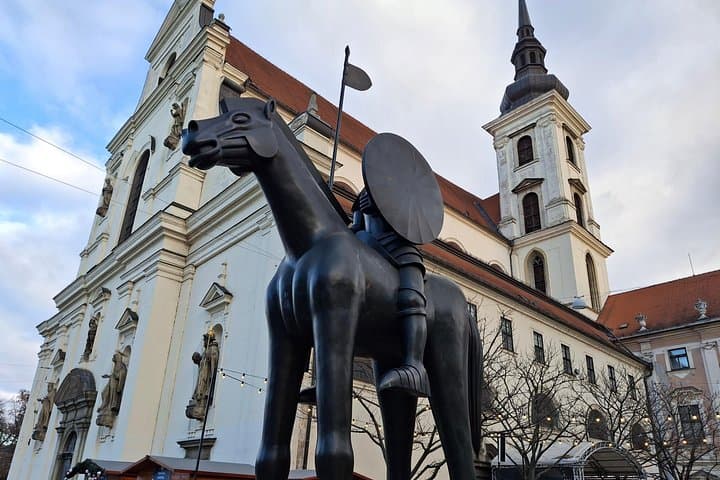 Equestrian statue of Margrave Jošt of Luxembourg on Moravian Square in Brno, a striking bronze work rising directly from the pavement as a symbol of courage and civic identity.