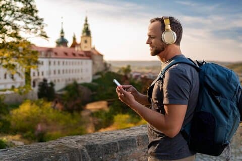 Traveler listening SmartGuide in Kutná Hora