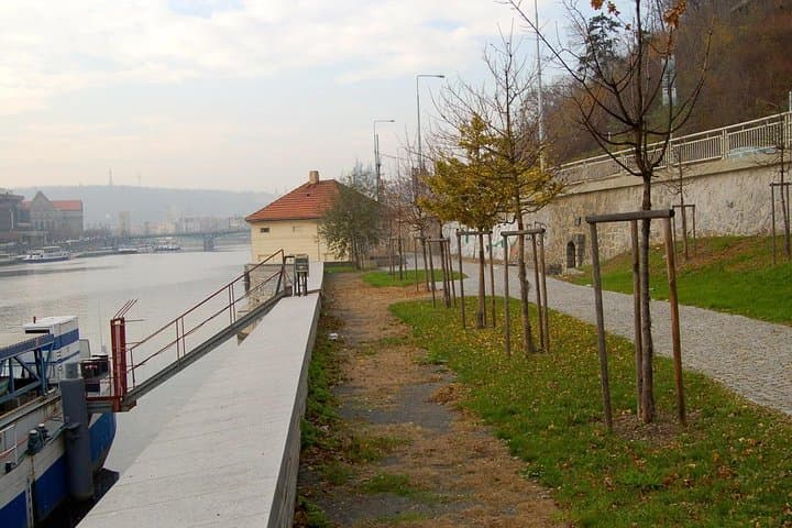 Vltava riverside with the entrance of the tunnel, which leads the water through the hill.