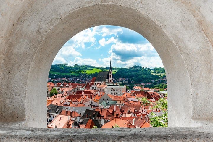 From the castle heights, tiled rooftops tumble toward the river in a perfectly preserved medieval maze.