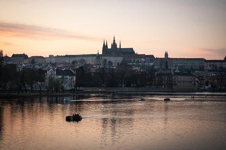 Prague Castle silhouetted as the sun sets behind it