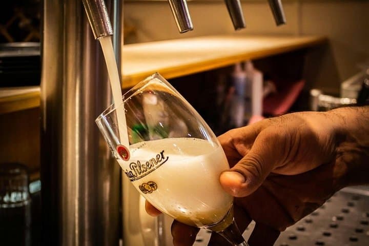 Pouring the Pilsner Urquell beer during the beer tasting in the original brewery.
